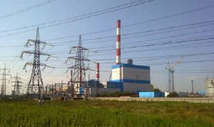 A power plant with many towers and wires.