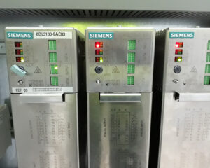 Three metal cabinets with green lights on them.