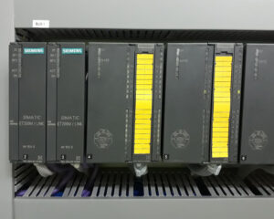 A row of computer terminals on top of a rack.