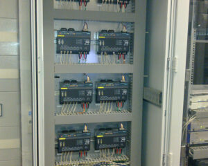 A large electrical panel with many wires and switches.