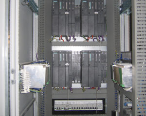 A large rack of electrical equipment in an industrial setting.