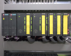 A rack of computer terminals with yellow labels.