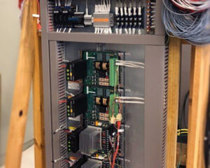 A large metal cabinet with many wires and controls.