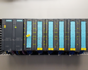 A row of computer terminals with yellow and blue labels.