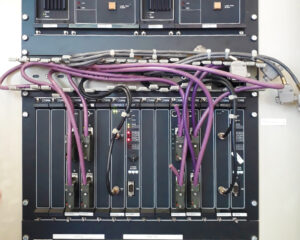 A bunch of wires are connected to the back of a server.