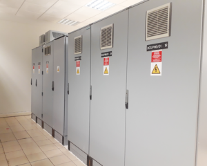 A row of electrical cabinets in an industrial setting.
